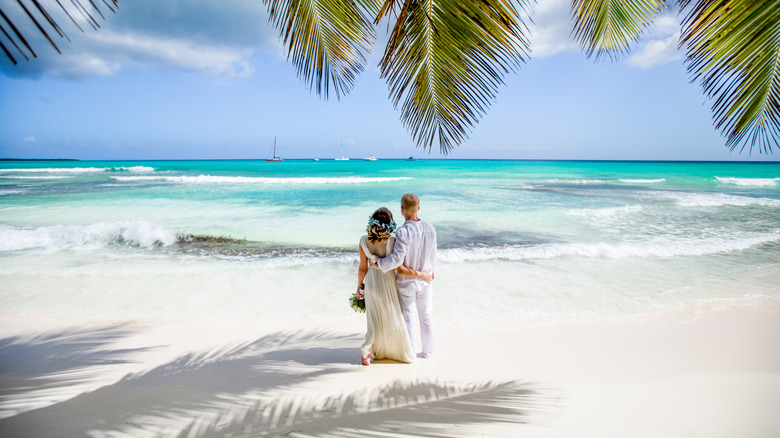 Newlywed couple white sand beach