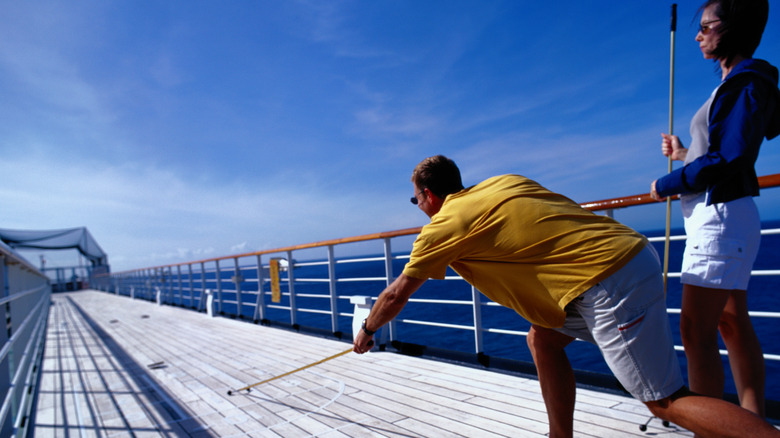 couple playing shuffleboard on cruise