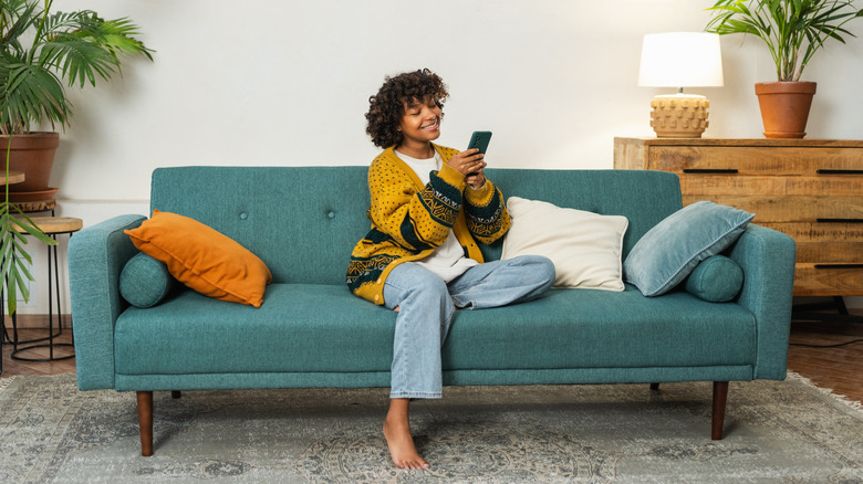 woman with cellphone on couch