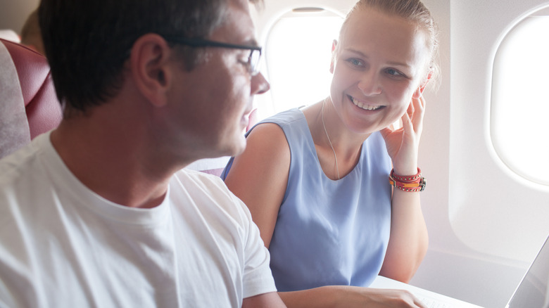 couple chatting on flight