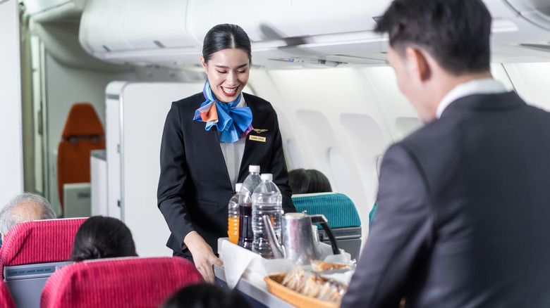 Flight attendants with food cart