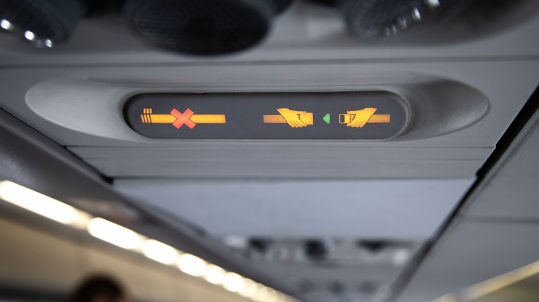 Illuminated seatbelt sign on plane
