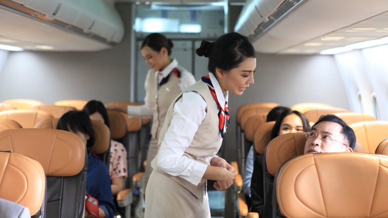 Flight attendants serving customers