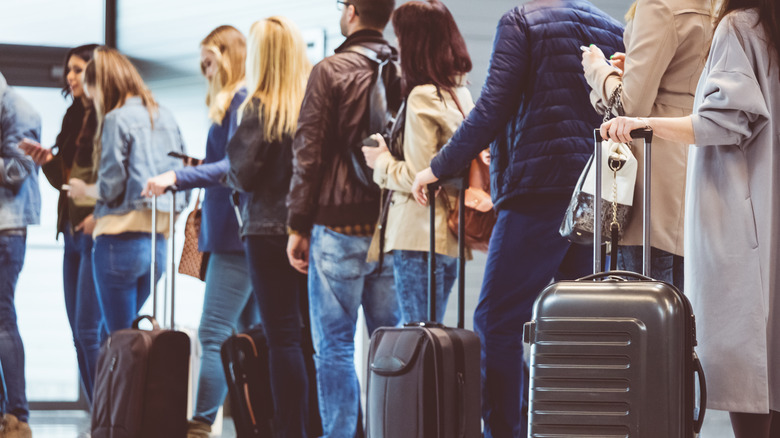 people standing in boarding line 