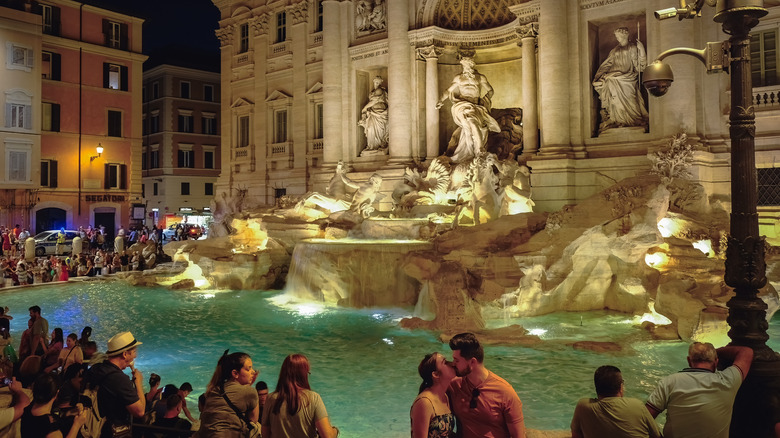 Busy Trevi Fountain at night