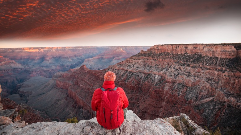 Person sitting at Grand Canyon sunset