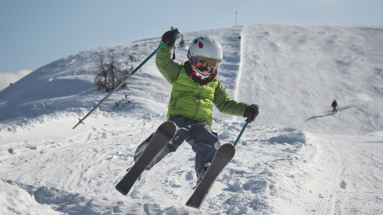 A young skier taking on a jump