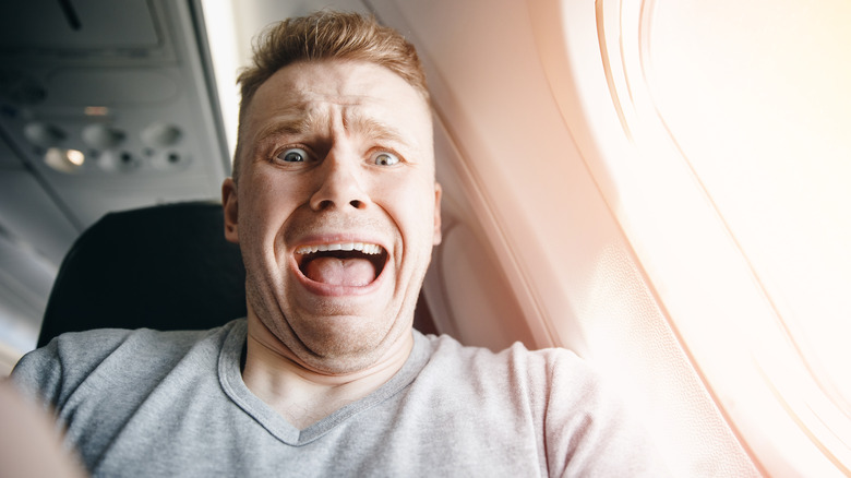 Scared man on plane