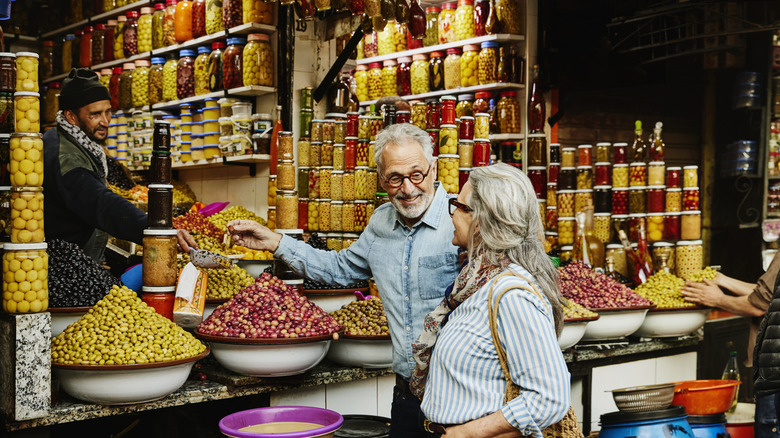 Older couple shops at a colorful spice market