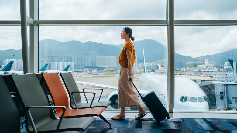 A woman walking through an airport