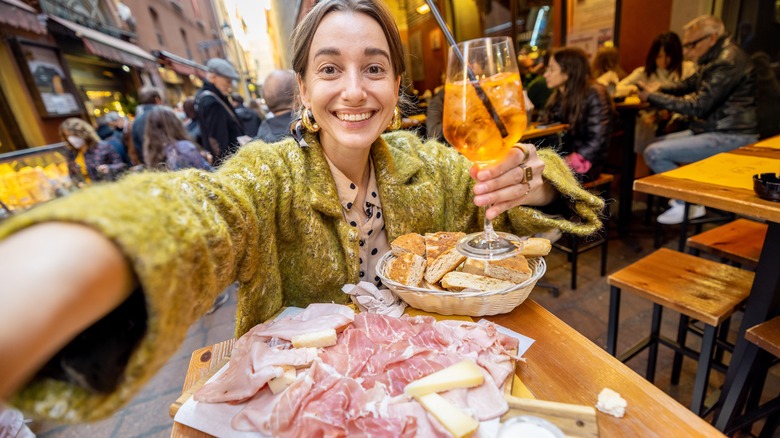Smiling traveler enjoying a plate of food