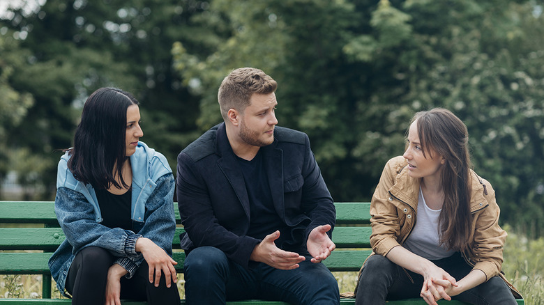 friends talking on park bench