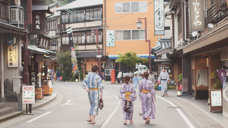 Visitors in kimonos walk the streets of Kimosake Onsen