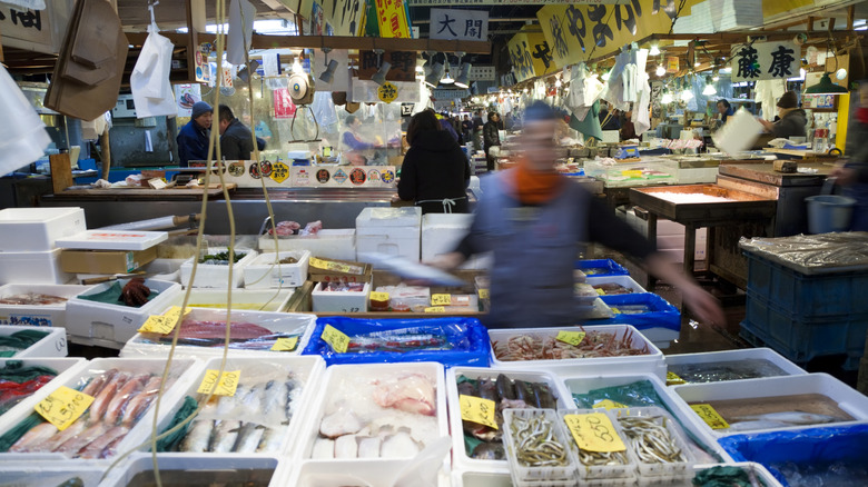 Workers prepare seafood displays at Tsukiji Fish Market