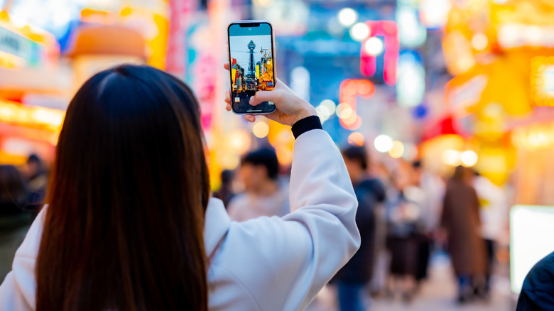 Woman taking a photo in a crowded place