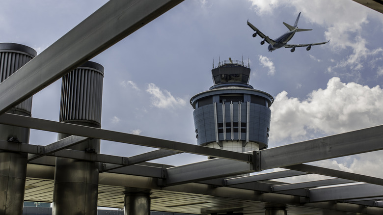 A plane flies over LaGuardia Airport.