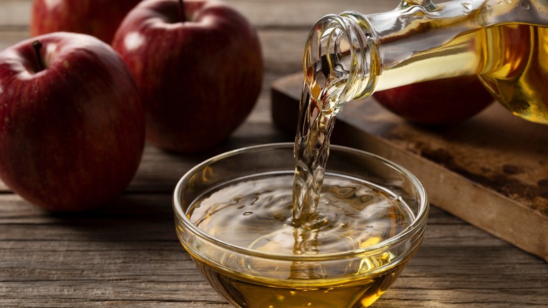 Pouring apple cider vinegar