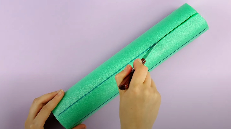 Cutting a pool noodle lengthwise