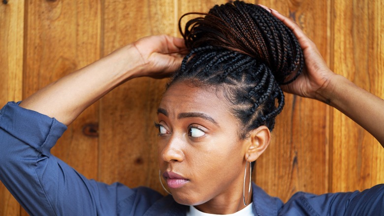 Woman putting her hair up