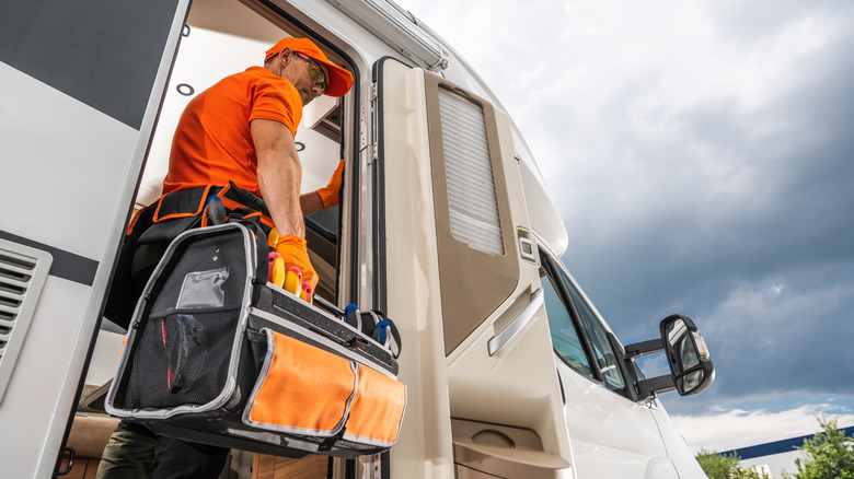 RV technician standing in vehicle