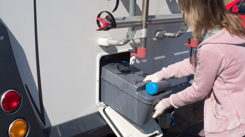 RV traveler emptying black water tank