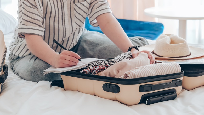 Woman packing a suitcase