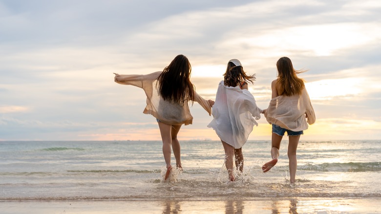 Friends walking on a beach