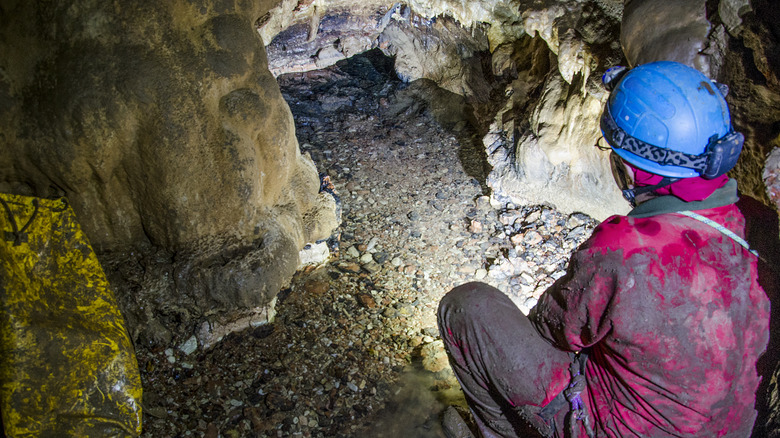 Person exploring a cave