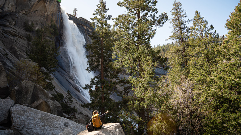 Woman sitting on a rock near Nevada Falls