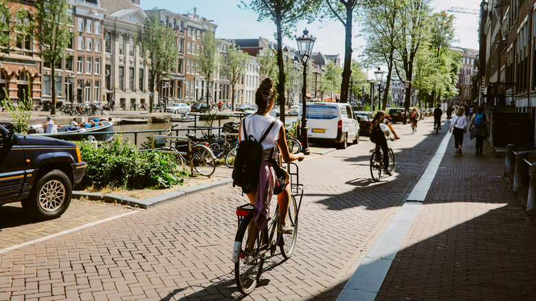 woman cycling along a canal