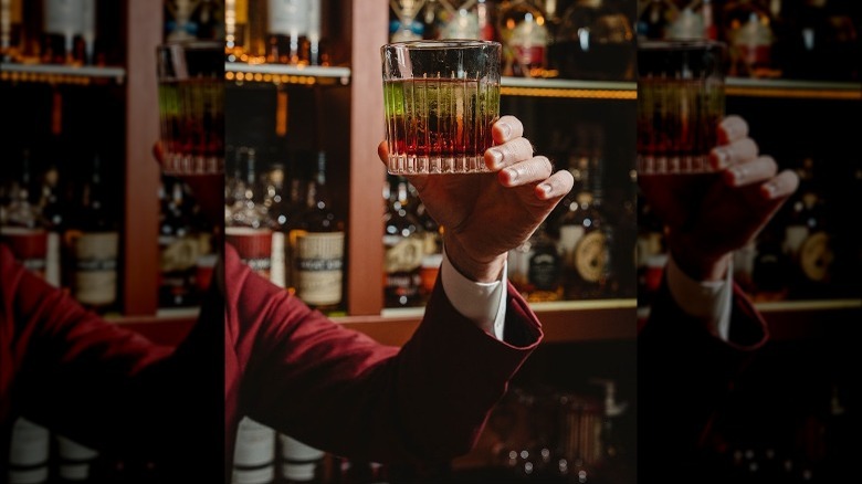 A bartender shows off a cocktail at Red Frog