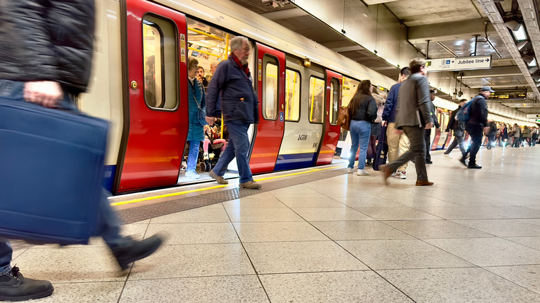 Passengers step off a train in the London Underground