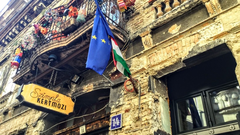 old building with sign and terrace