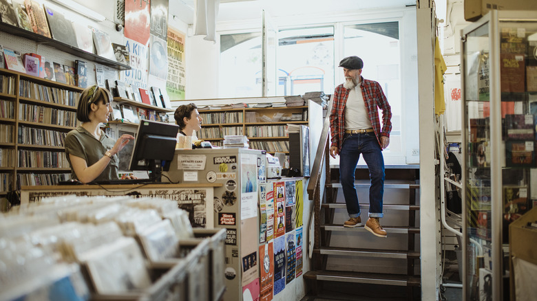 Man greets staff at store