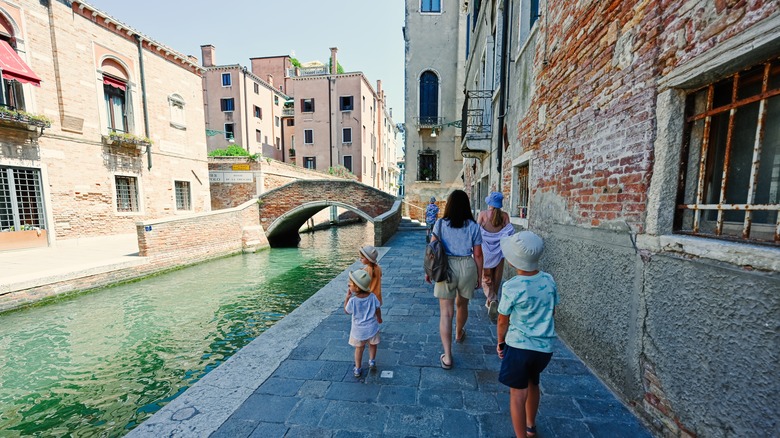 Family walking along a canal