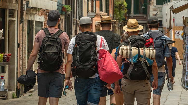 Backpackers walking on Venice street