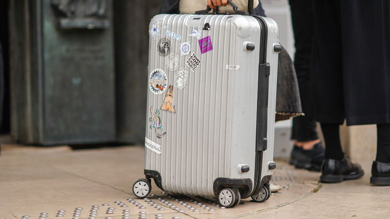A suitcase with stickers all over it
