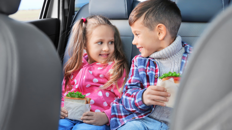 Kids with sandwiches in car