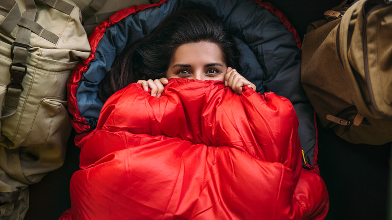 Woman hiding in sleeping bag