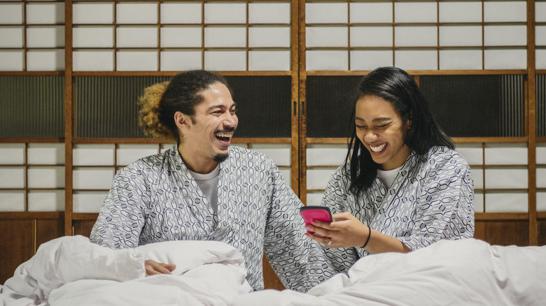 people laughing in matching pajamas