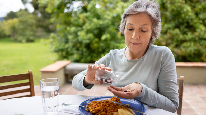 Woman taking medicine