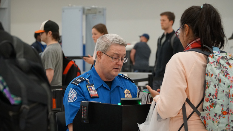 TSA worker looking at ID