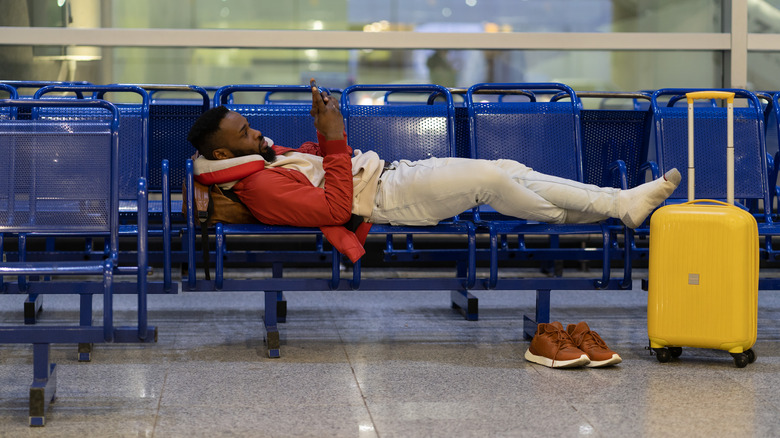 man sleeping at the airport