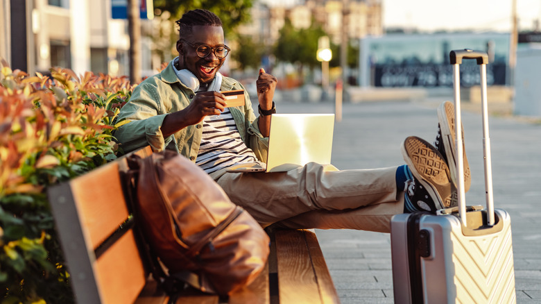 traveling man using credit card