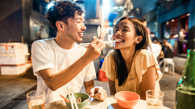 Couple eating Chinese street food