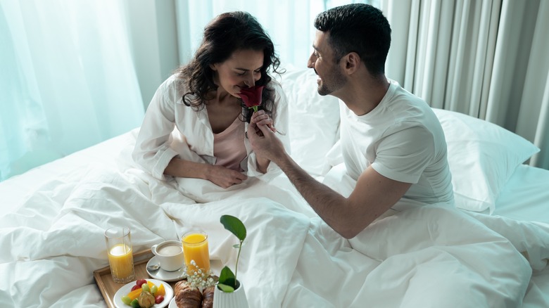 couple sharing breakfast in bed