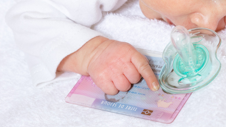 baby touching passport