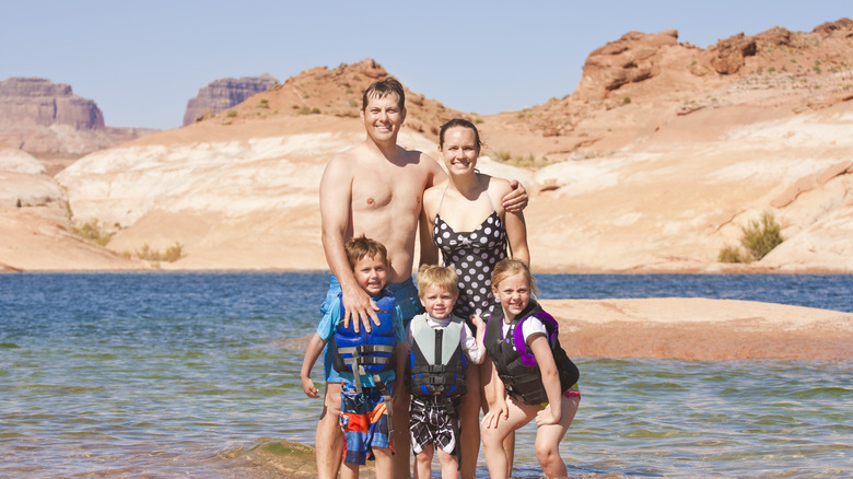 a family wading at Lake Mead