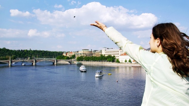 woman waving from bridge