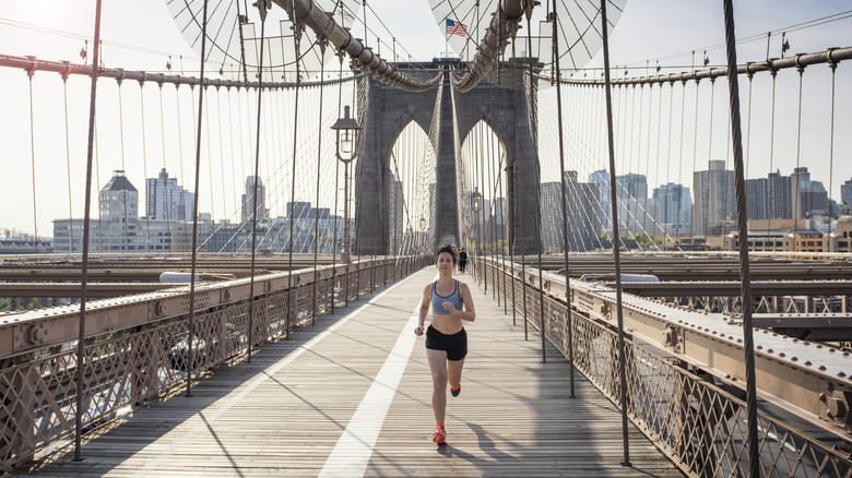 Woman jogs across Brooklyn Bridge